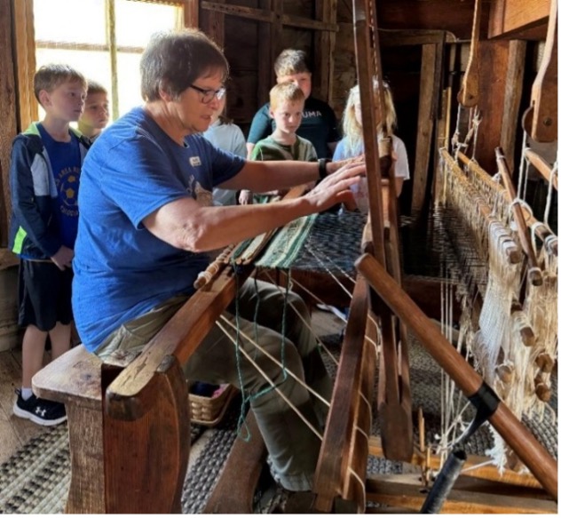 Gloria Peterson demonstrating the loom